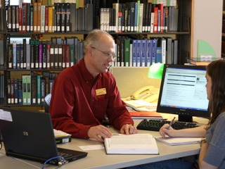 A student gets research help in the library.