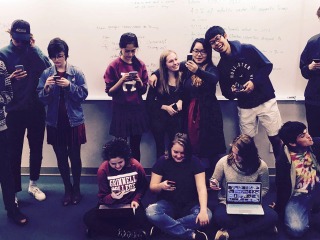 Students using their electronics in a class picture of the Social Media tutorial