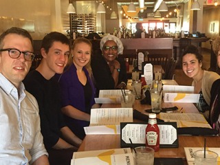 Mixed group of faculty and students sitting in a restaurant