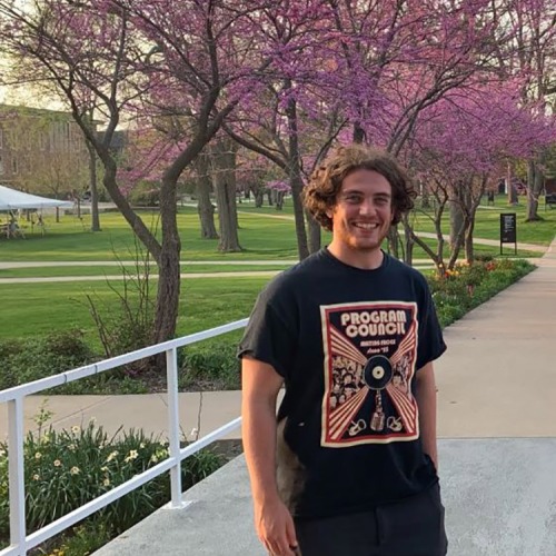 Finn Dworkin at Grinnell, redbud trees in bloom