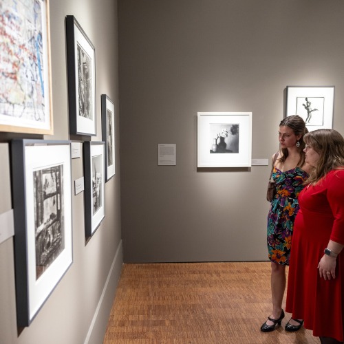 two students looking at art 