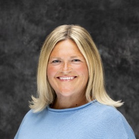 Woman in light blue with blonde hair