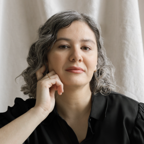 Author photo showing latina woman with curly black hair