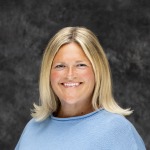 Woman in light blue with blonde hair