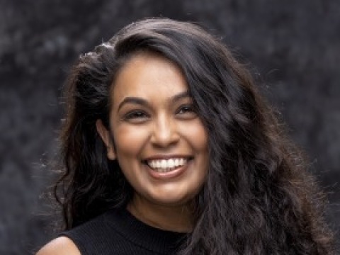 A woman smiles for a headshot