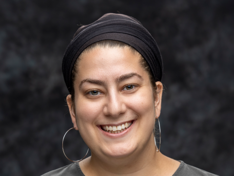 A woman smiles for a headshot