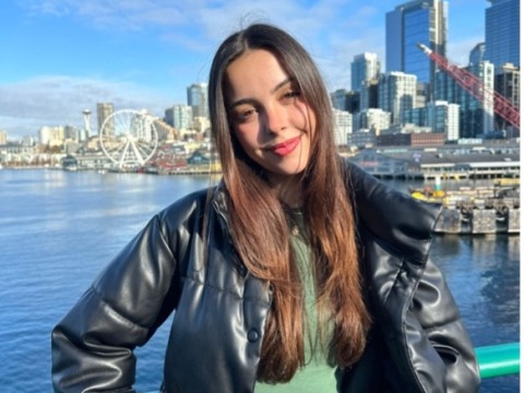 Laura Alvarez Ibanez standing in front of a river with cityscape in background