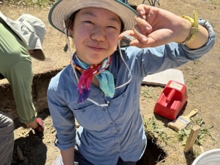 Avajane Lei '28 with a Chinese brown glazed stoneware fragment she uncovered on site.
