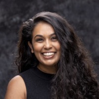 A woman smiles for a headshot
