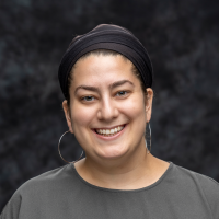 A woman smiles for a headshot