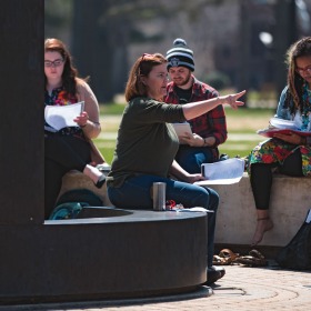 Students attend class outside.