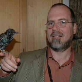 Robert Hampton hold a bird on his finger
