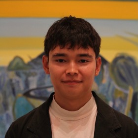 Person standing in front of a wall with stripes in the background