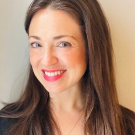 woman with long dark hair with light cream background