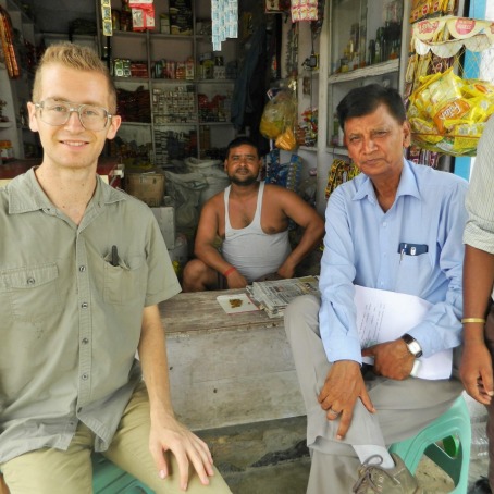 Anthony Wenndt sitting with farmers in India