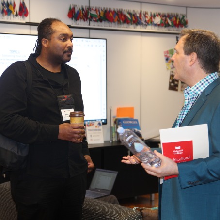 Emerson Williams-Molett ’07, left, speaks to Randell Christopher ’87 at the Connect and Share Workshop Saturday in the HSSC Global Living Room.