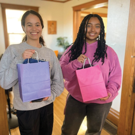 Julianna Gaddis and Bethle Ayele holding gift bags