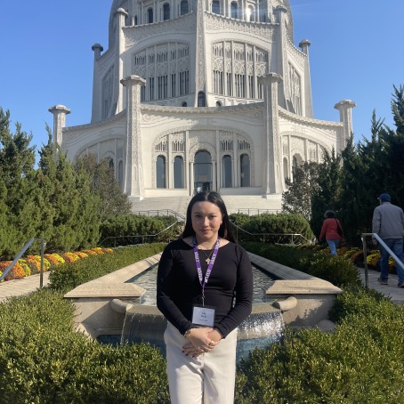Lily Piede standing in front of a domed white building.