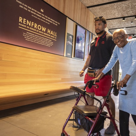 Edith Renfrow Smith walking with Nino in Renfrow Hall 