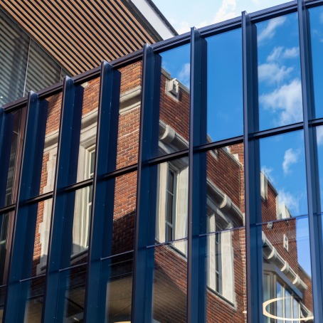 part of HSSC brick building reflecting in glass windows