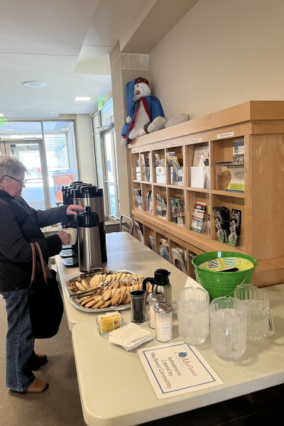 women getting coffee and cookies at the drake library