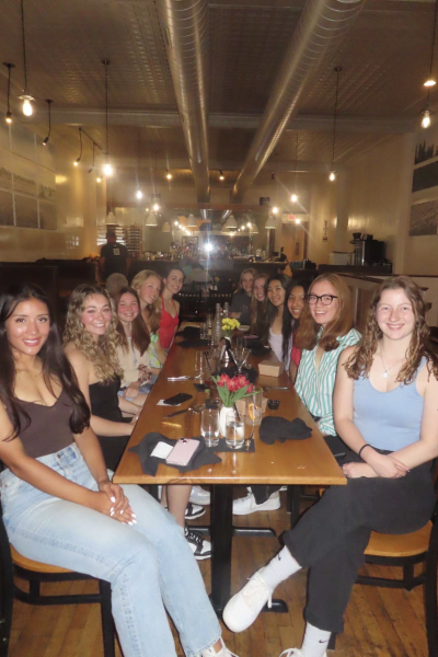A group of young women sits at a table in a restaurant