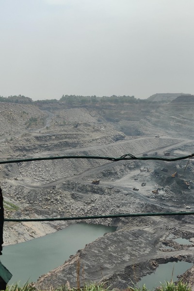 A coal mine in India with a big water-filled pit