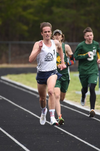 James running in a high school track meet